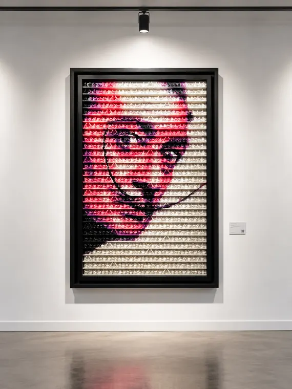 Portrait built from rows of small cast hands in pink, black and white